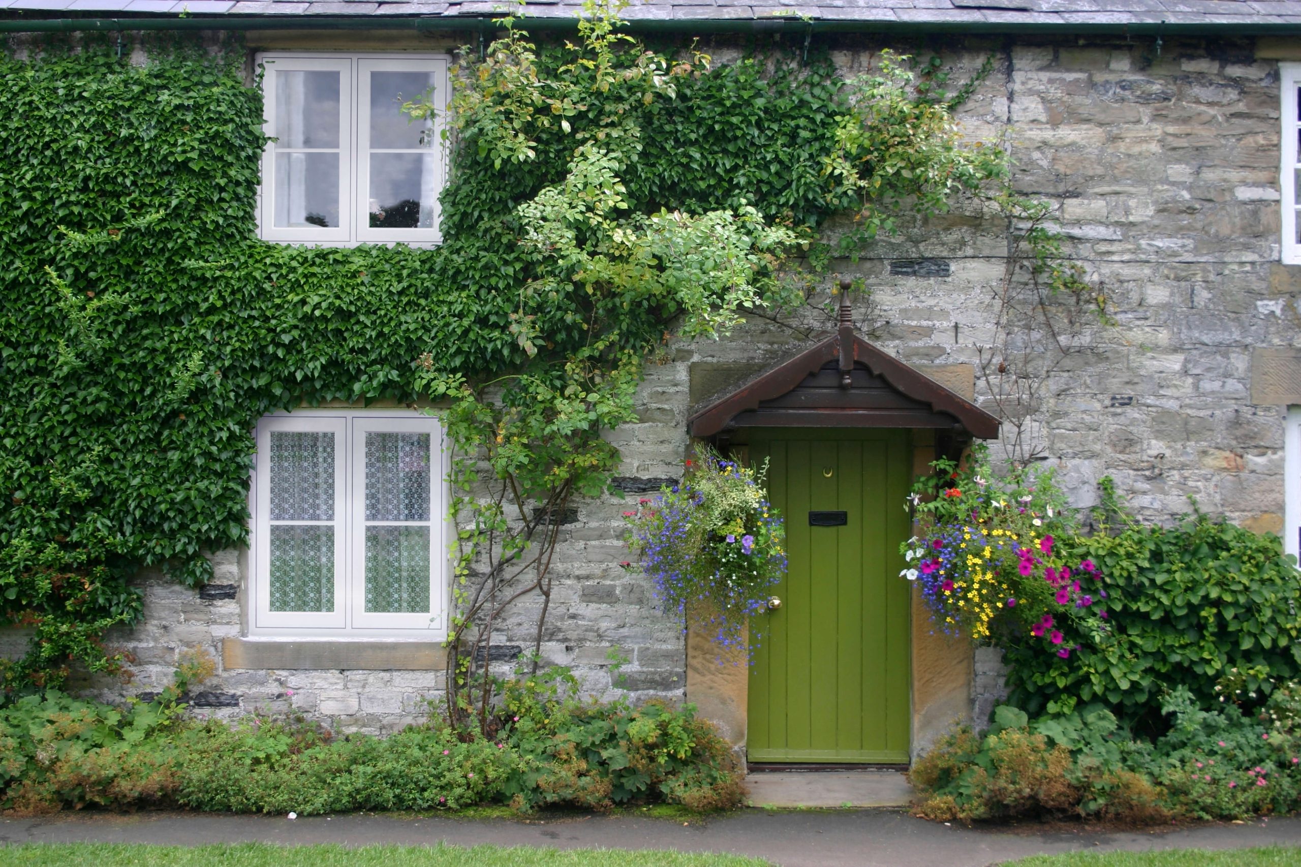 Green front door and white flush sash windows